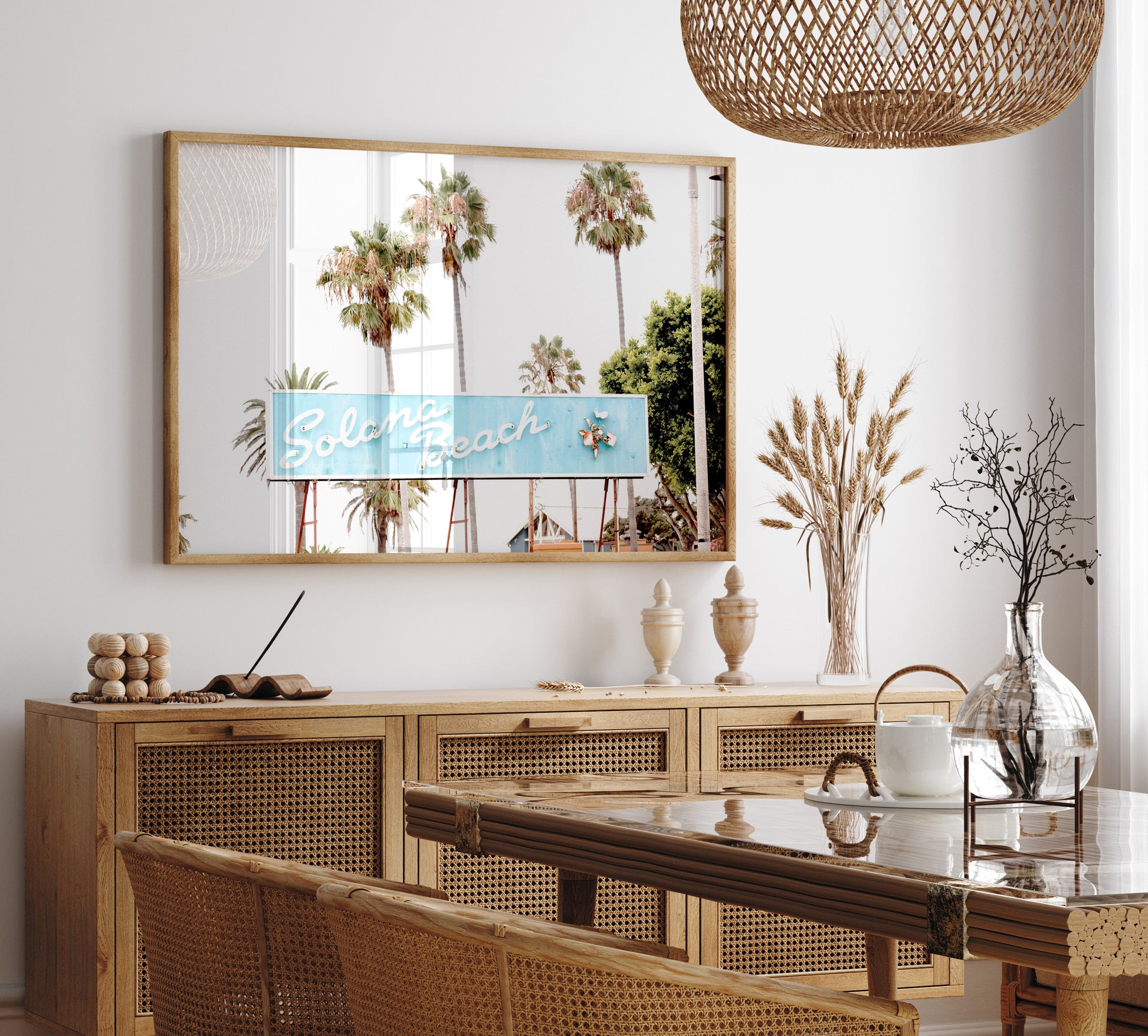 Colorful travel photography capturing the iconic 'Solana Beach' sign, a quintessential piece of Surf Signs San Diego art. The retro light blue sign, adorned with white cursive script and a unique steer head logo, is set against a backdrop of towering palm trees and a bright, hazy California sky. This Southern California surf beach sign evokes strong summer vibes and is perfect for coastal decor. Photograph in minimalist framed mock up.