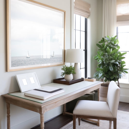 Minimalist ocean print featuring two sailboats on a calm ocean under a vast, bright sky. This serene seascape is ideal for coastal, nautical theme wall art. Photograph in minimalist mock up