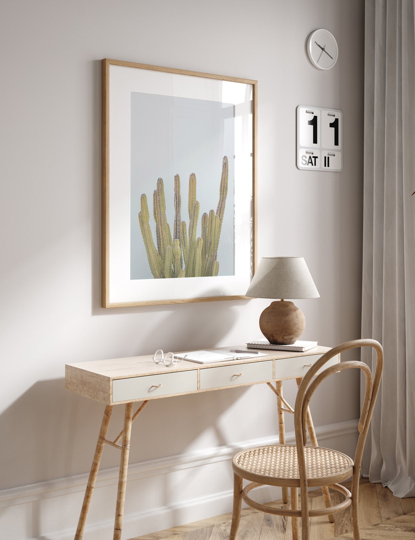 Vertical minimalist art print of a striking green cactus against a plain pale blue sky background, offering a unique element for tropical decor or minimalist art. Photograph in minimalist mock up.