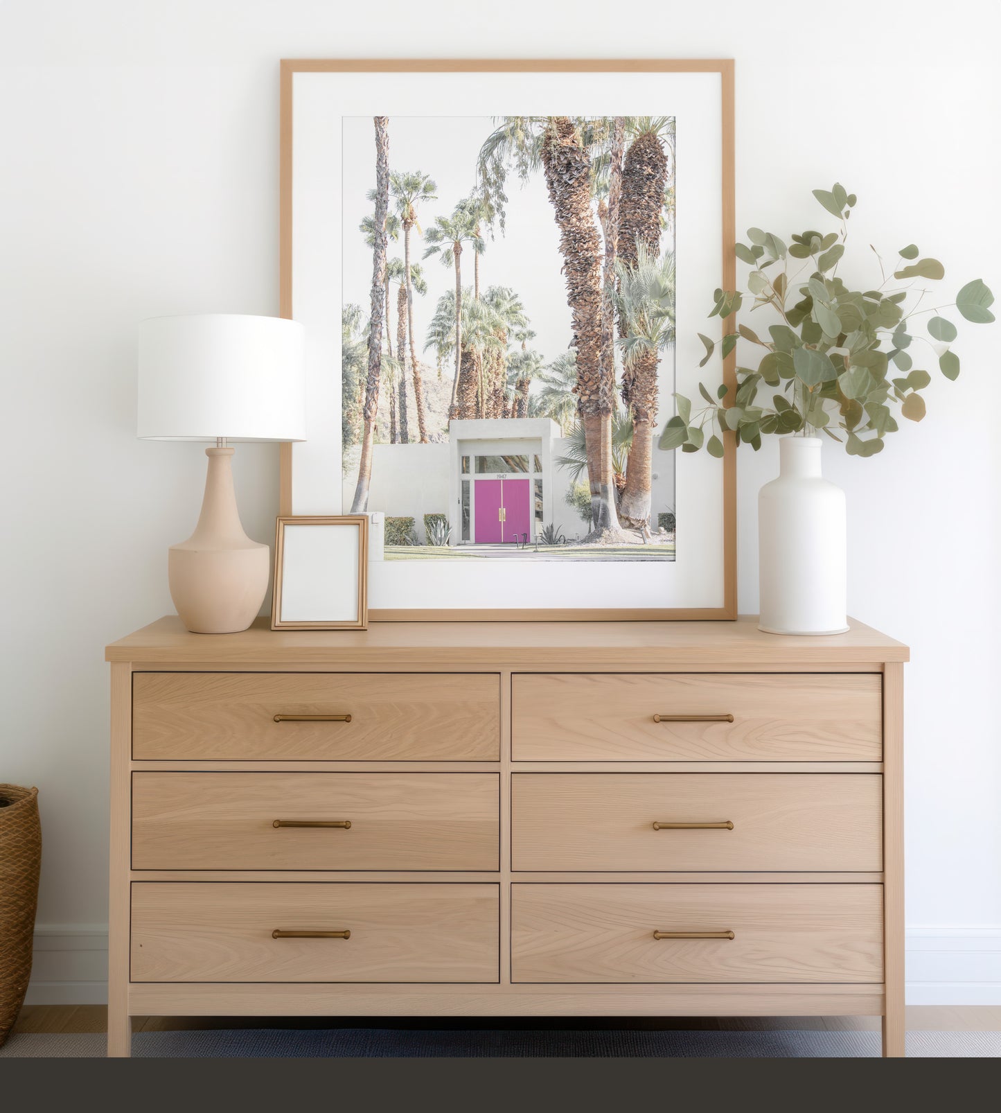 Vertical tropical print featuring a Palm Springs residence with a vibrant pink door, framed by numerous tall palm trees. This image is a fun beach photography style print. Photograph in minimalist mock up.