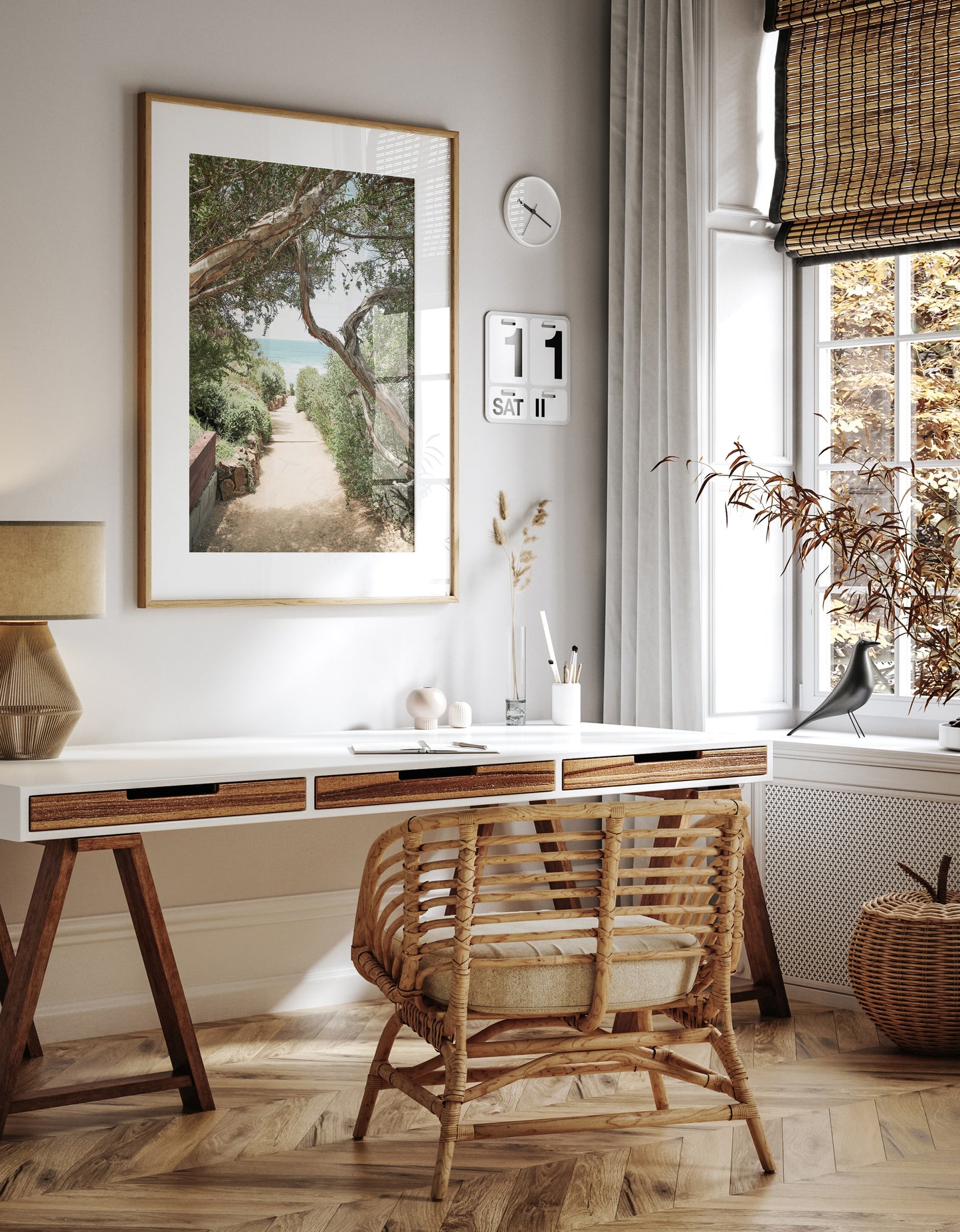 A serene landscape coastal photography print showing a path leading down to the ocean, framed by lush coastal foliage and winding branches. This vertical coastal photography piece captures the beauty of the Seaside Beach, on the California coast, perfect for a beach house decor. Photograph in minimalist mock up.