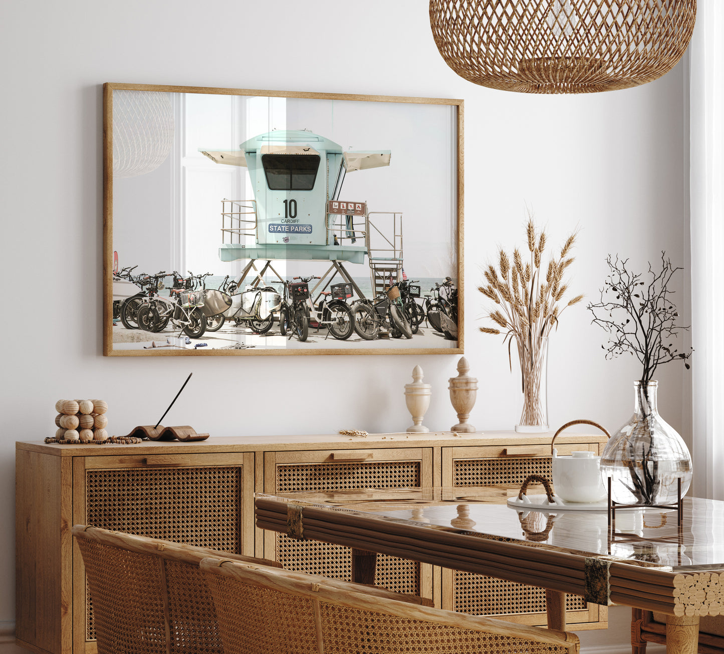 Captured in a horizontal San Diego print, a light blue Lifeguard Tower (number 10) stands prominently among numerous bicycles are parked nearby. Located in Seaside Beach, San Diego, California. Photograph in minimalist mock up.