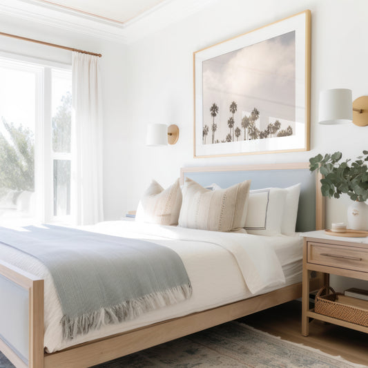 Landscape tropical print of multiple palm trees silhouetted against a cloudy or foggy sky, conveying a tranquil, coastal vibe. Photograph in minimalist mock up.