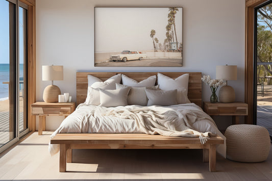 Landscape beach photography featuring a vintage white car parked on a coastal road with tall palm trees and a lifeguard tower nearby, overlooking the ocean. Photograph in minimalist mock up.