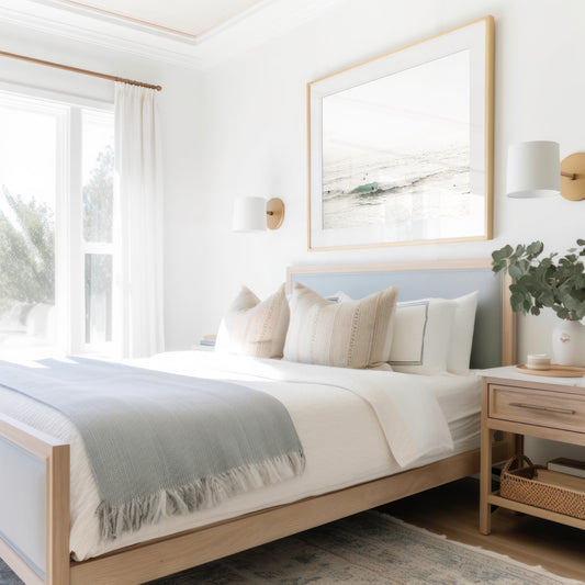 Fine art of horizontal landscape print by Southern California photographer Kim Dybczak of Salt Creek Prints, featuring a bright image captures a pale sandy beach giving way to a vast, light gray ocean with gentle waves. Several surfers are scattered across the water, some sitting on their boards and others riding small waves. The sky is a uniform, pale white, creating a soft, overcast atmosphere, located in Windansea Beach in La Jolla, California. Photograph in framed minimalist mock up