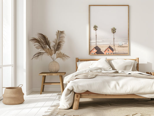 Vertical coastal photography of Oceanside, California, showing beachfront houses and a lifeguard tower with two prominent palm trees overlooking the ocean. A minimalist surf print. Photograph in minimalist mock up.