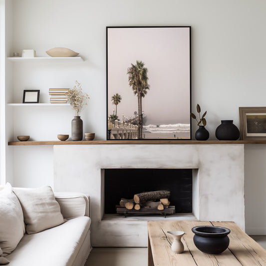 Vertical beach art of Huntington Beach Pier and tall palm trees under a soft sky, with ocean waves breaking on the shore. Photograph in minimalist mock up.