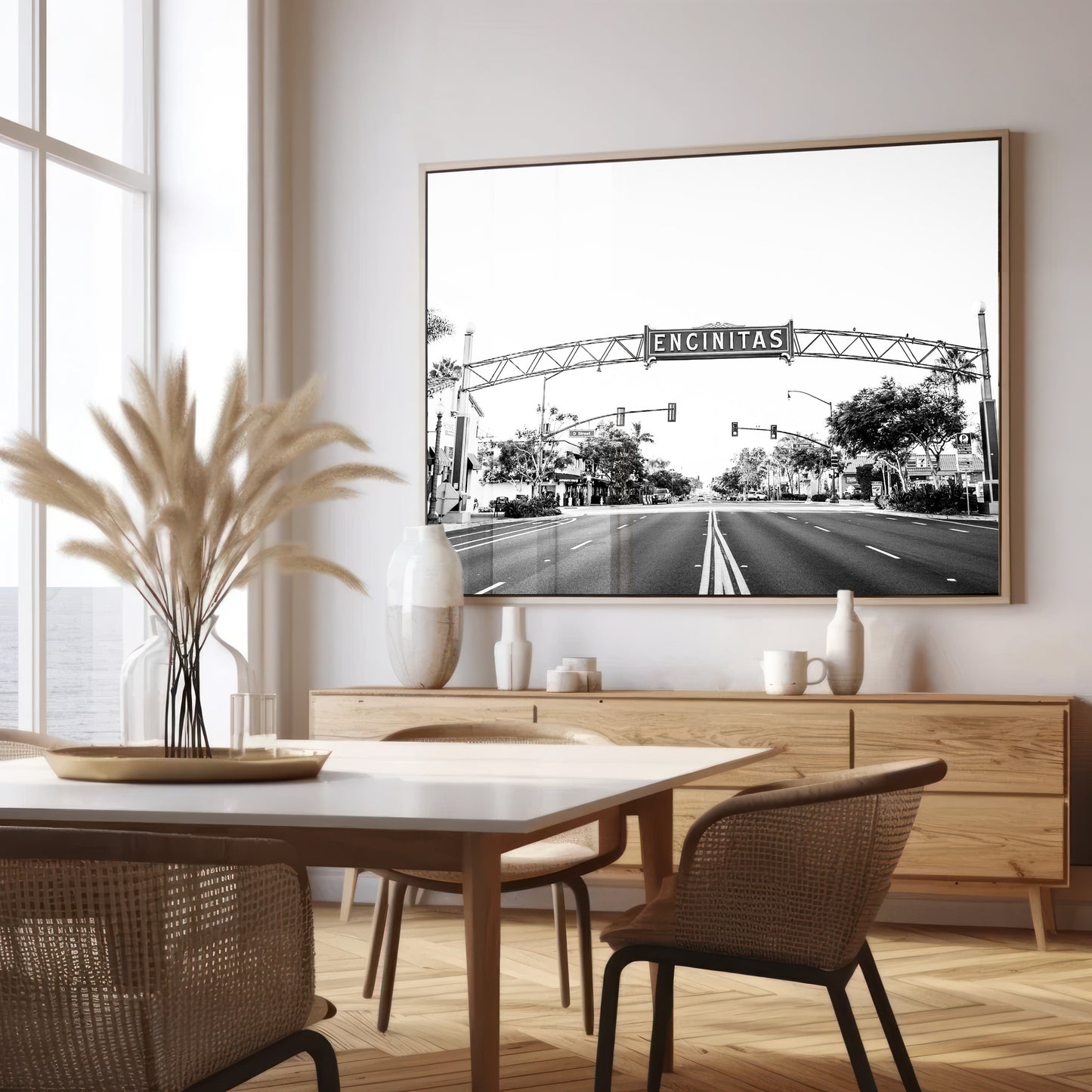 A black and white photograph of a street sign that reads 'Encinitas' with a background of a city street. Photograph in minimalist mock up.