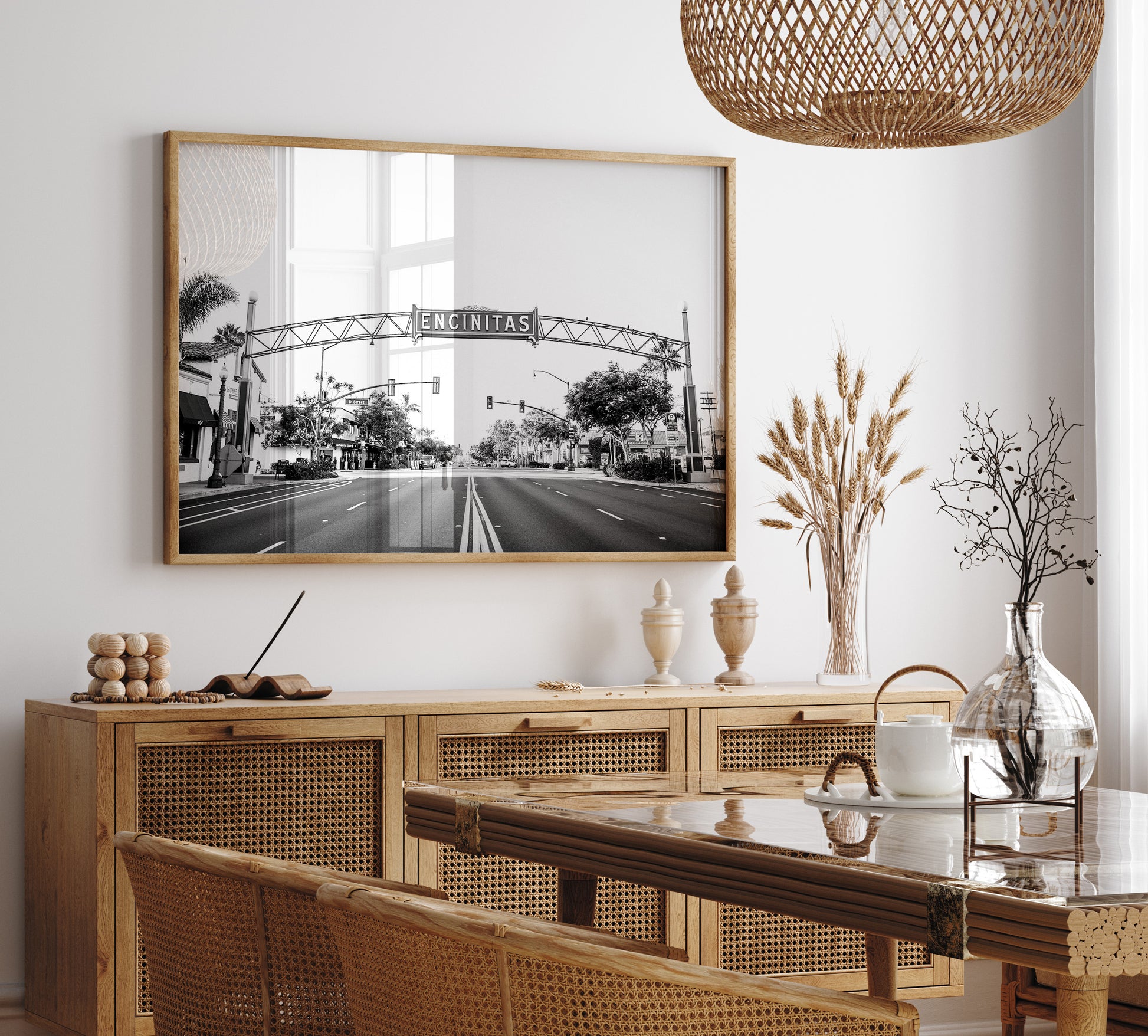 A black and white photograph of a street sign that reads 'Encinitas' with a background of a city street. Photograph in minimalist mock up.