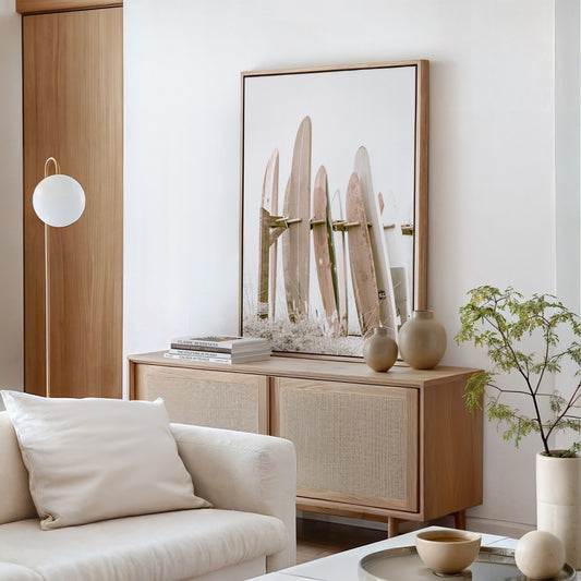 framed canvas print of surfboards lined up in neutral tones leaning on a console