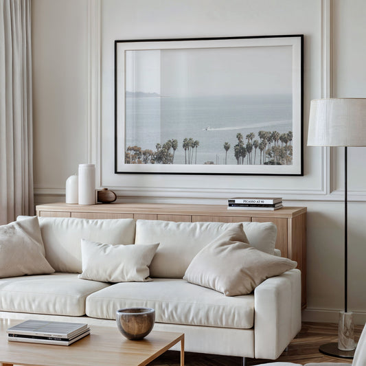 Landscape San Diego beach print showing a seascape with a boat gliding on the water with palm trees in the foreground. Photograph in minimalist mock up.