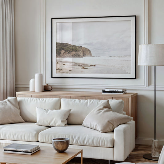 Minimalist ocean print of ocean waves and large sandy cliffs in the distance overlooking the seascape. Photograph in minimalist mock up.