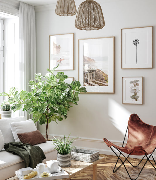 Captivating Torrey Pines San Diego coast scene, presented as vertical beach art. This piece of travel photography features a prominent bridge extending over a wide sandy beach with calm ocean waves. A coastal road winds along the base of rugged cliffs, with a lone coastal palm tree adding a touch of tropical essence to this Southern California seascape print. Photograph in minimalist mock up