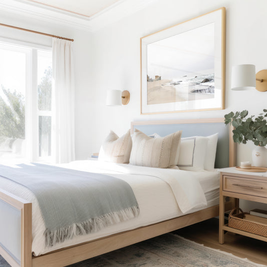 Horizontal coastal photography featuring a beach scene with calm ocean waves and a white sky, with rocks in the distance, located in Laguna California. Photograph in minimalist mock up.