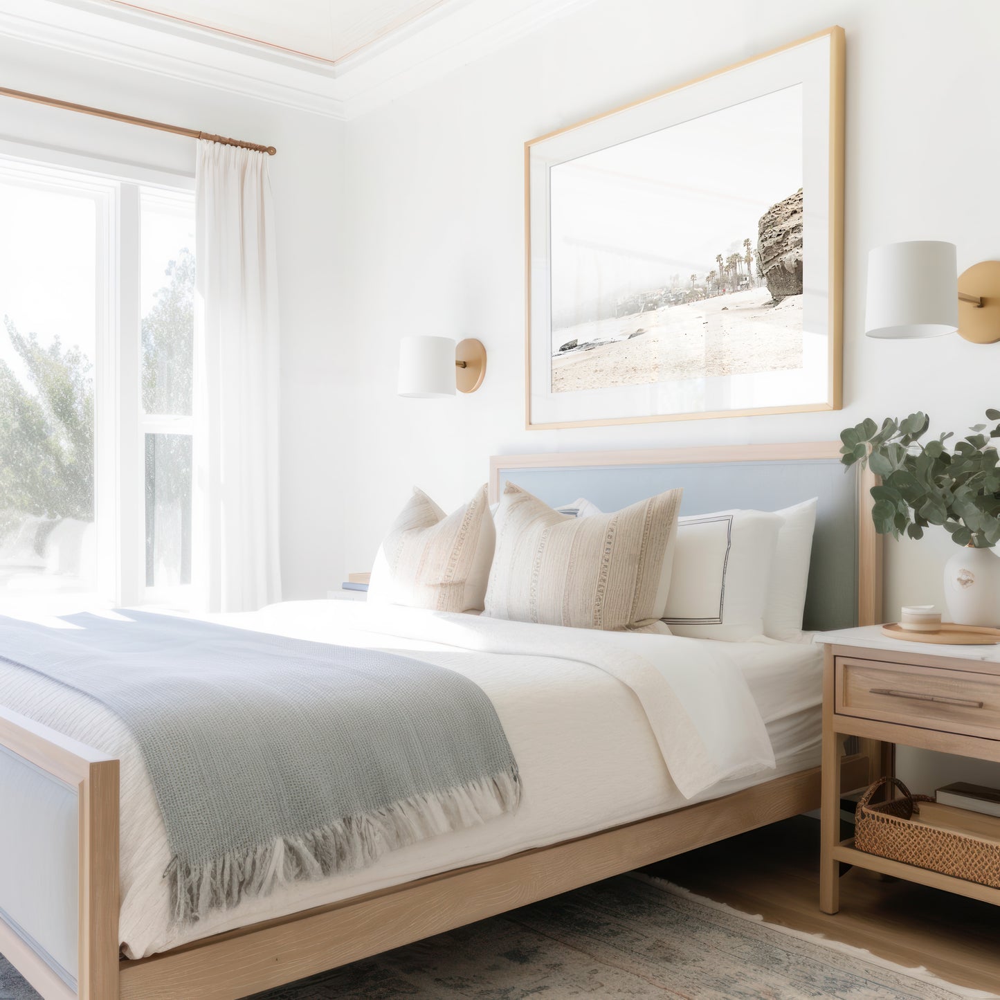 Horizontal coastal photography featuring a beach scene with a calm ocean and a rocky shore, beach homes in the foggy distance, located in Laguna California. Photograph in minimalist mock up.