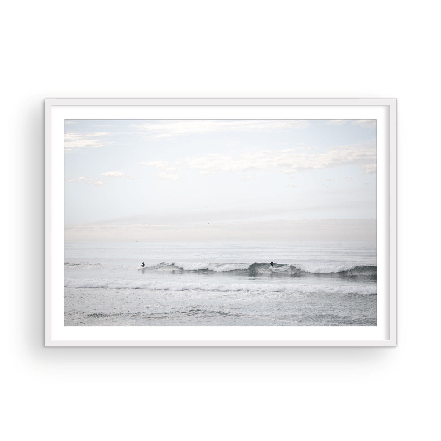 Horizontal minimalist ocean art with a close-up blue waves print of water, featuring subtle ripples and soft textures, ideal as a neutral ocean print, surfers in the waves. Photograph in minimalist mock up.