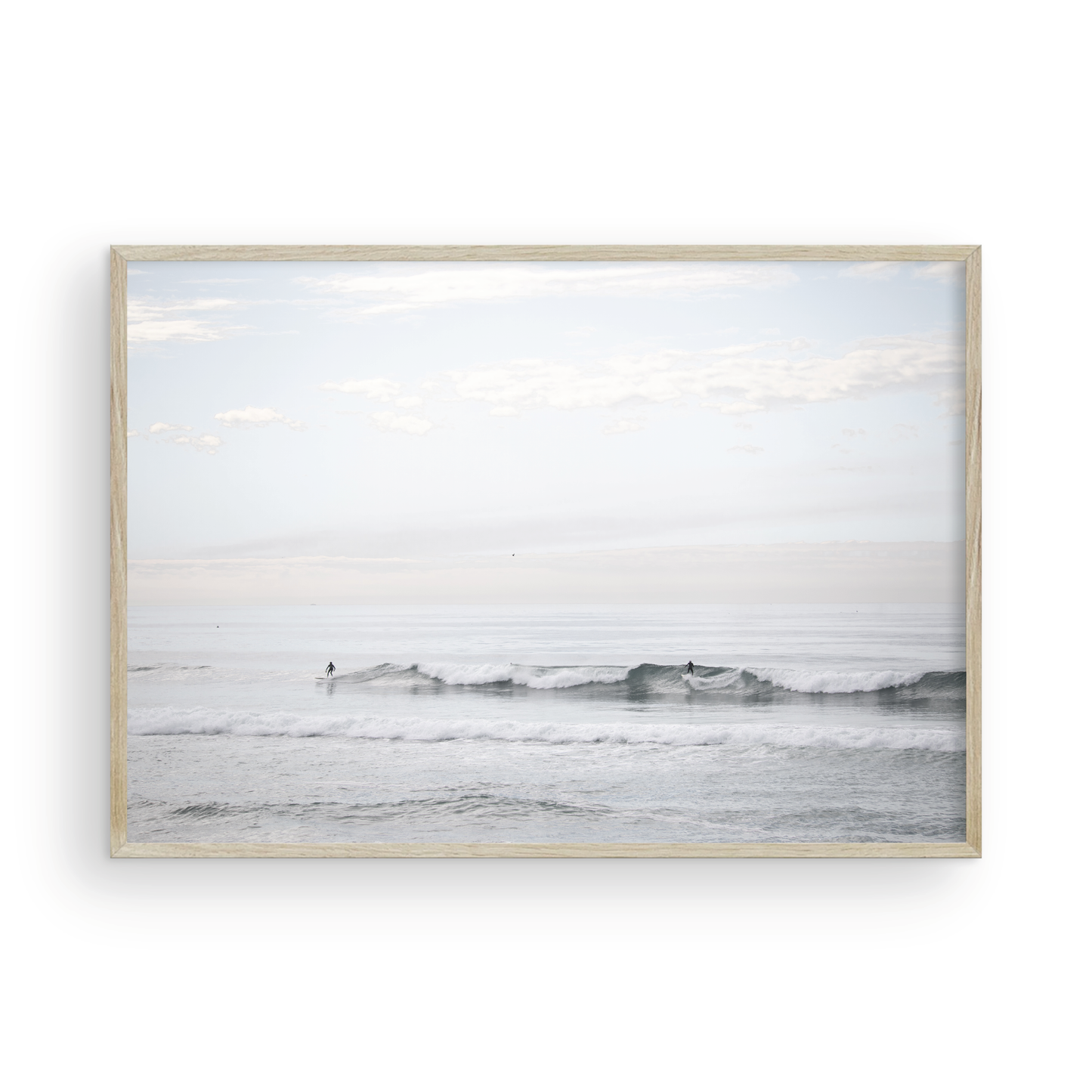 Horizontal minimalist ocean art with a close-up blue waves print of water, featuring subtle ripples and soft textures, ideal as a neutral ocean print, surfers in the waves. Photograph in minimalist mock up.