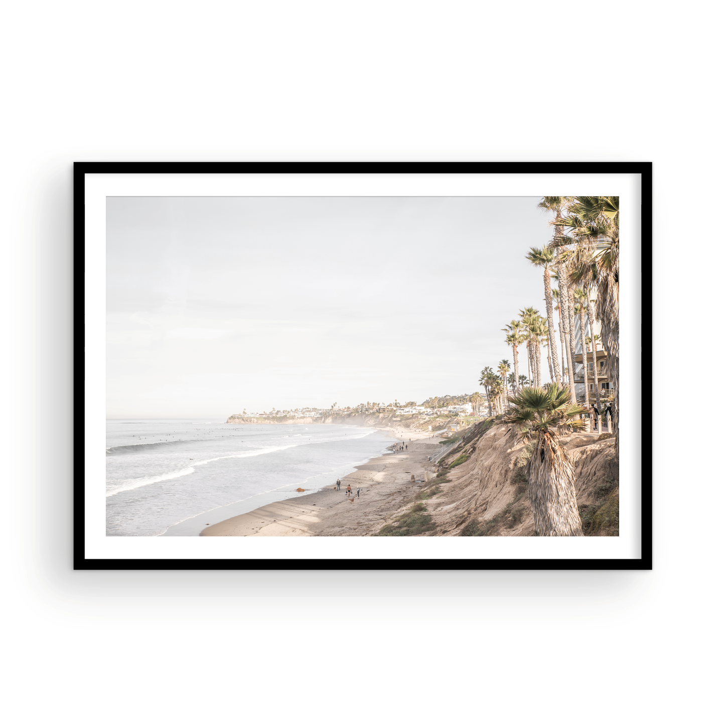 Horizontal, California coast print featuring a high vantage point overlooking Pacific Beach, with tall palm trees, a sandy beach, and the ocean. This coastal print offers a beautiful seascape. Photograph in minimalist mock up.