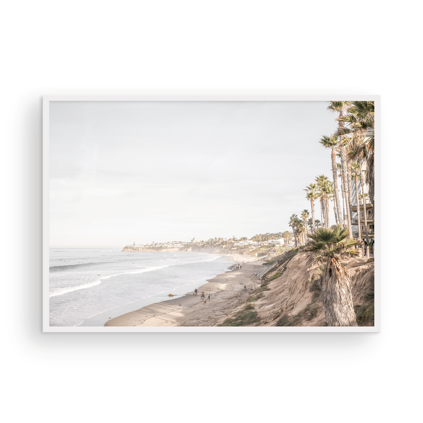 Horizontal, California coast print featuring a high vantage point overlooking Pacific Beach, with tall palm trees, a sandy beach, and the ocean. This coastal print offers a beautiful seascape. Photograph in minimalist mock up.