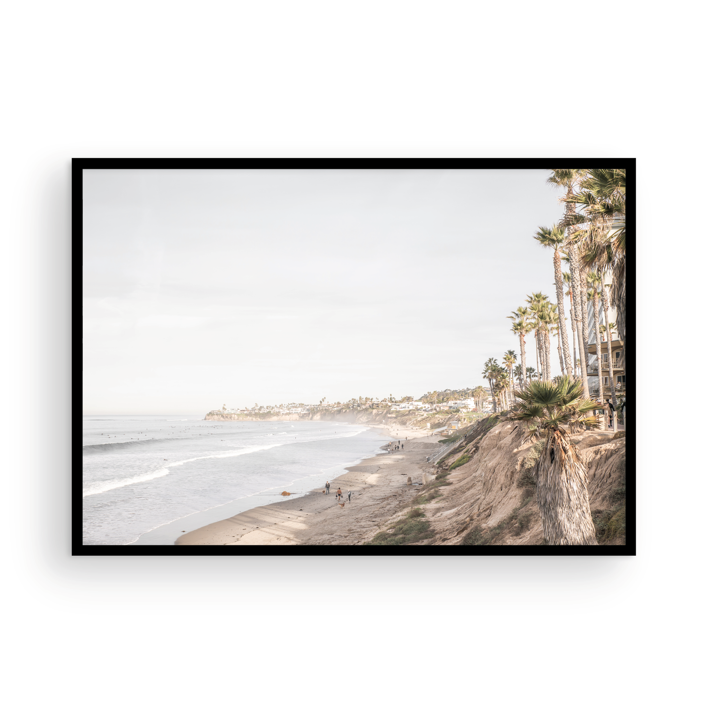 Horizontal, California coast print featuring a high vantage point overlooking Pacific Beach, with tall palm trees, a sandy beach, and the ocean. This coastal print offers a beautiful seascape. Photograph in minimalist mock up.