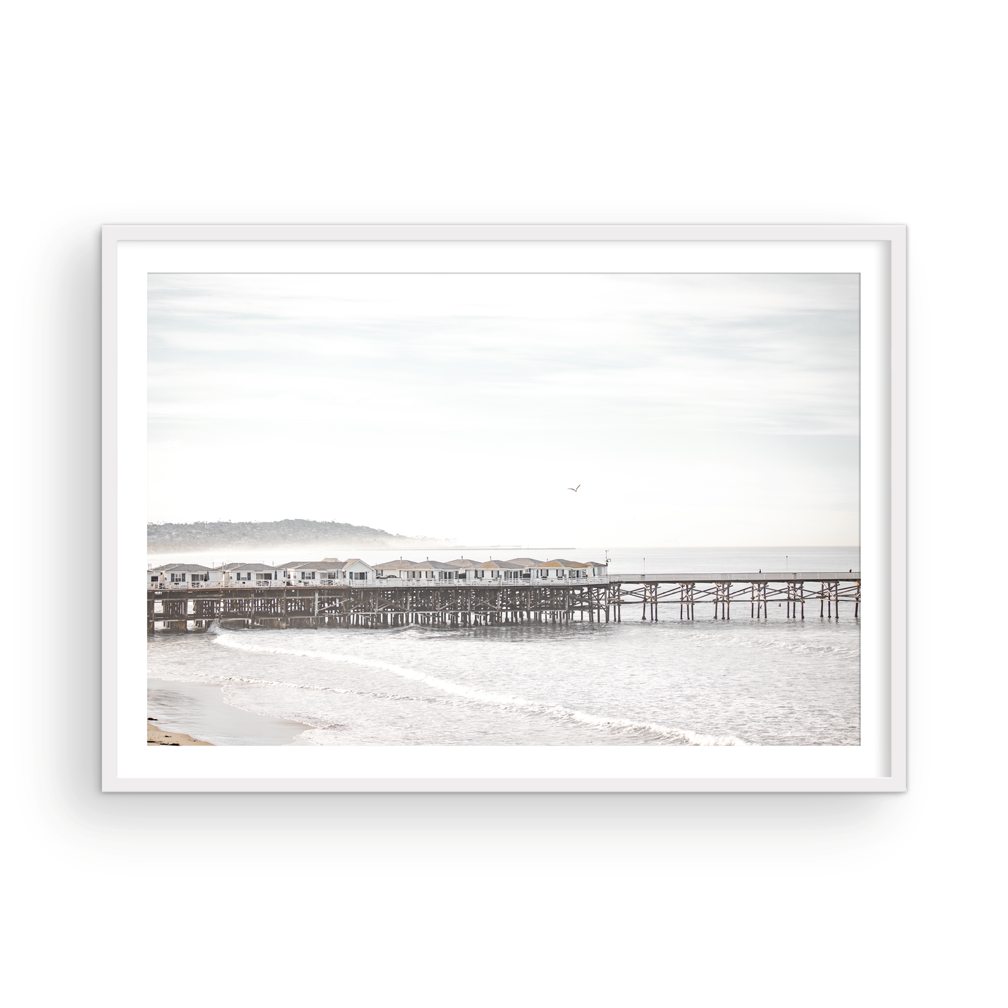 Landscape coastal photography of Crystal Pier in Pacific Beach, San Diego, extending into the calm ocean with gentle waves. Photograph in minimalist mock up