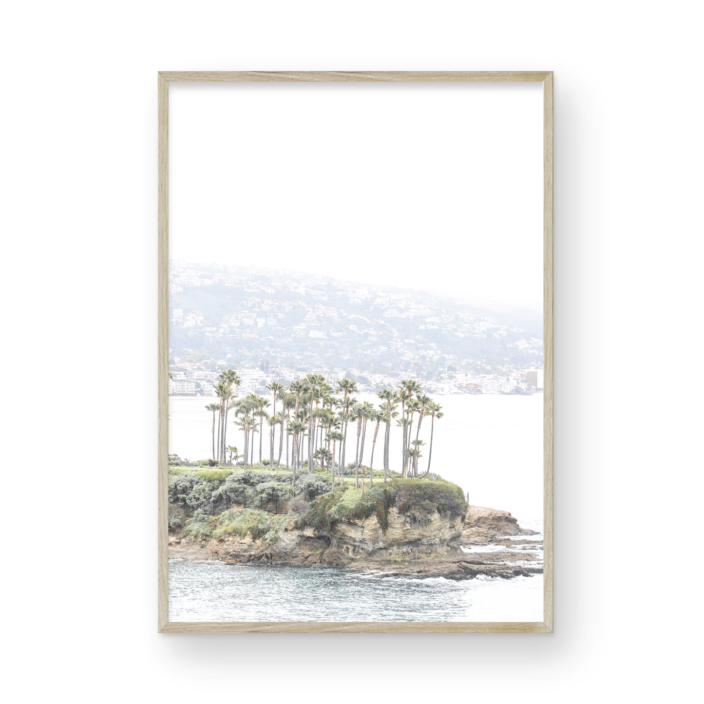 Vertical coastal photography of Laguna Beach, San Diego, featuring a fine art giclee print featuring palm trees on a small island in a body of water. Photograph in minimalist mock up.