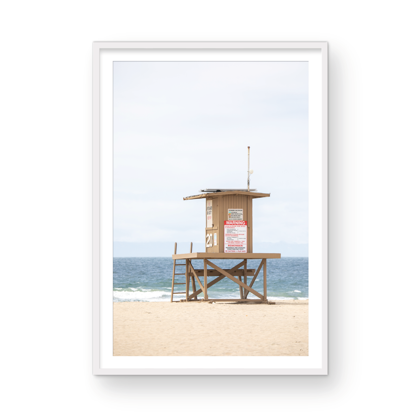 A wide landscape coastal photography view of Newport Beach in Southern California, featuring a lifeguard tower and walls on the beach. Photograph in minimalist mock up.