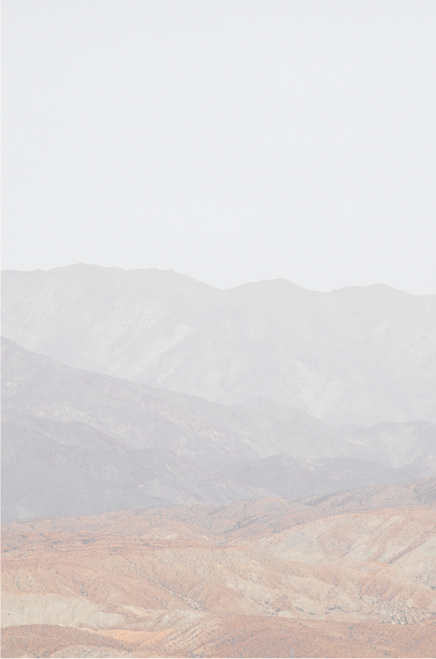 Minimalist art print of hazy mountains layered in soft tones, creating a calm ocean print aesthetic. This vertical minimalist art print can fit a neutral ocean print theme.