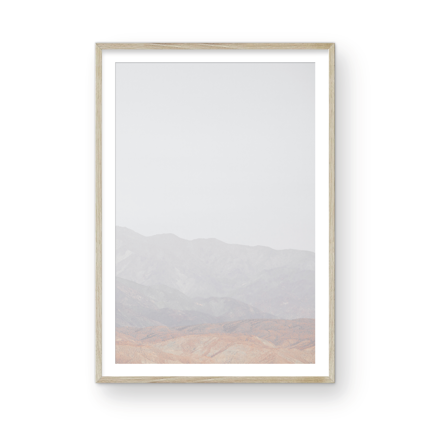 Minimalist art print of hazy mountains layered in soft tones, creating a calm ocean print aesthetic. This vertical minimalist art print can fit a neutral ocean print theme. Photograph in minimalist mock up.
