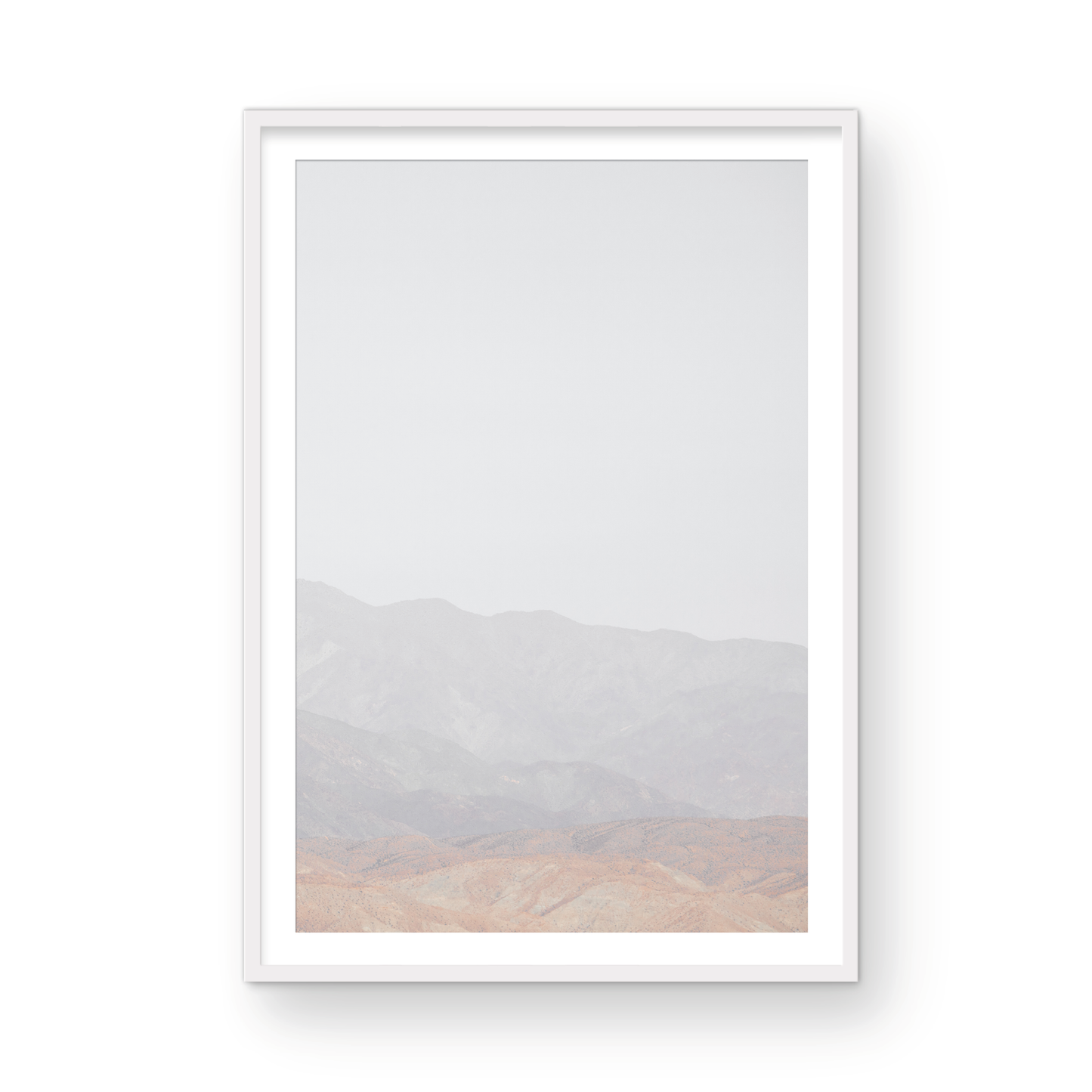 Minimalist art print of hazy mountains layered in soft tones, creating a calm ocean print aesthetic. This vertical minimalist art print can fit a neutral ocean print theme. Photograph in minimalist mock up.