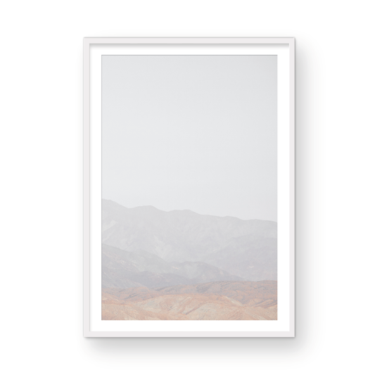 Minimalist art print of hazy mountains layered in soft tones, creating a calm ocean print aesthetic. This vertical minimalist art print can fit a neutral ocean print theme. Photograph in minimalist mock up.