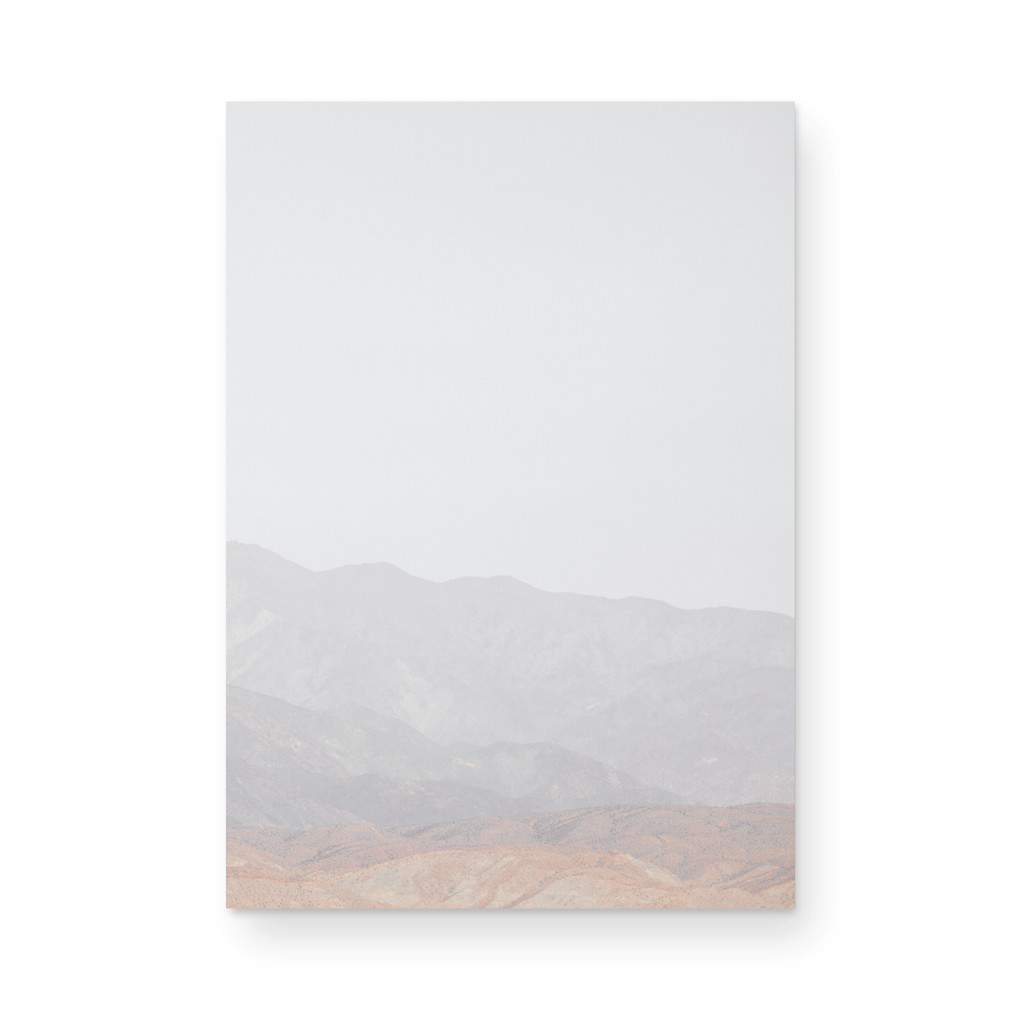 Minimalist art print of hazy mountains layered in soft tones, creating a calm ocean print aesthetic. This vertical minimalist art print can fit a neutral ocean print theme. Photograph in minimalist mock up.