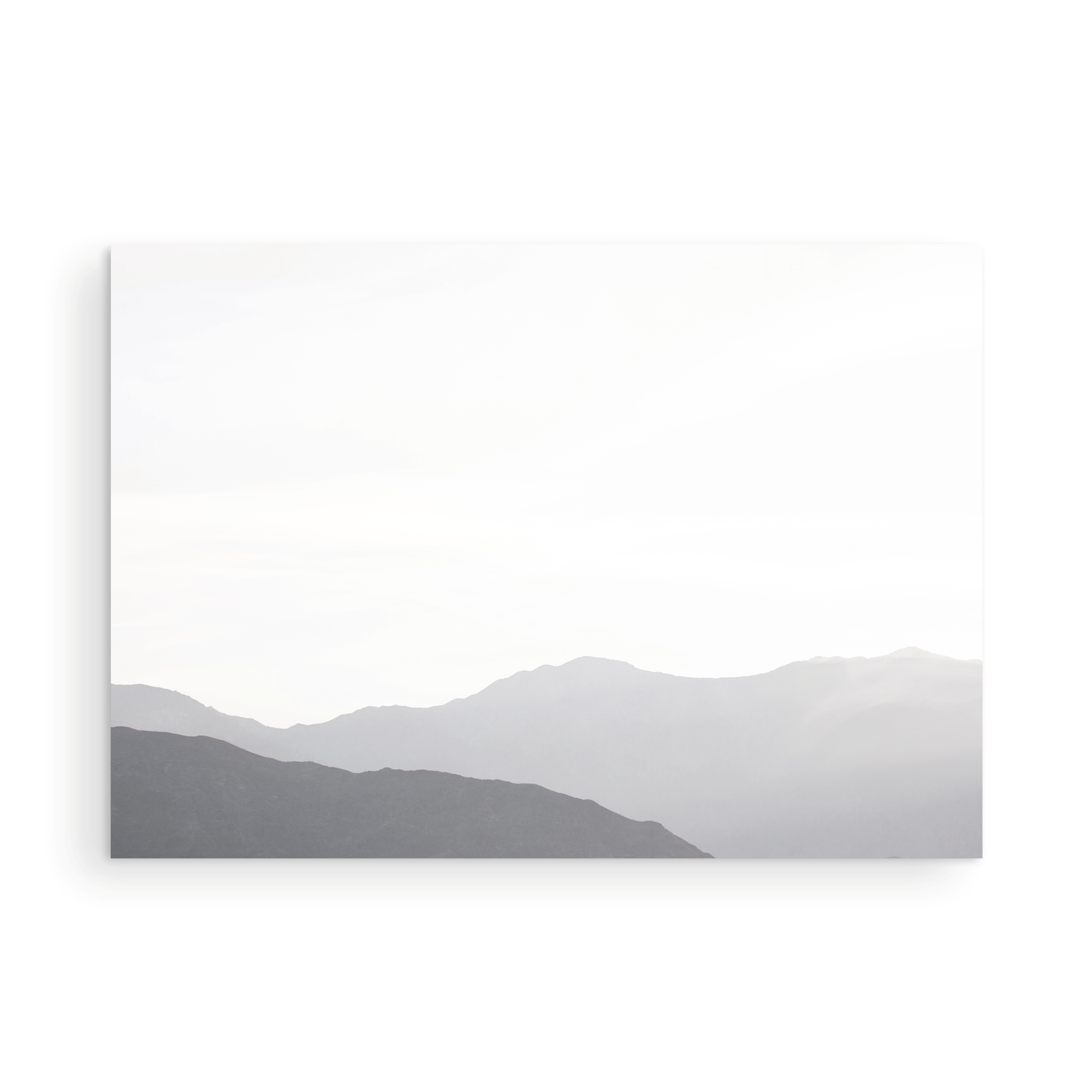 Minimalist horizontal art print of hazy mountains layered in soft tones. Located in Palms Springs, California. Photograph in minimalist mock up