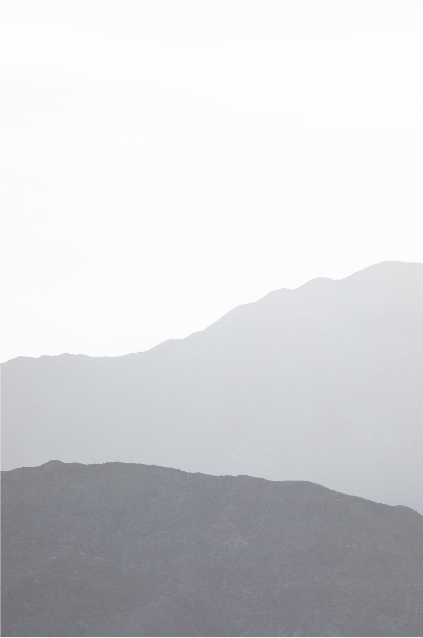 Minimalist vertical art print of hazy mountains layered in soft tones. Located in Palms Springs, California.
