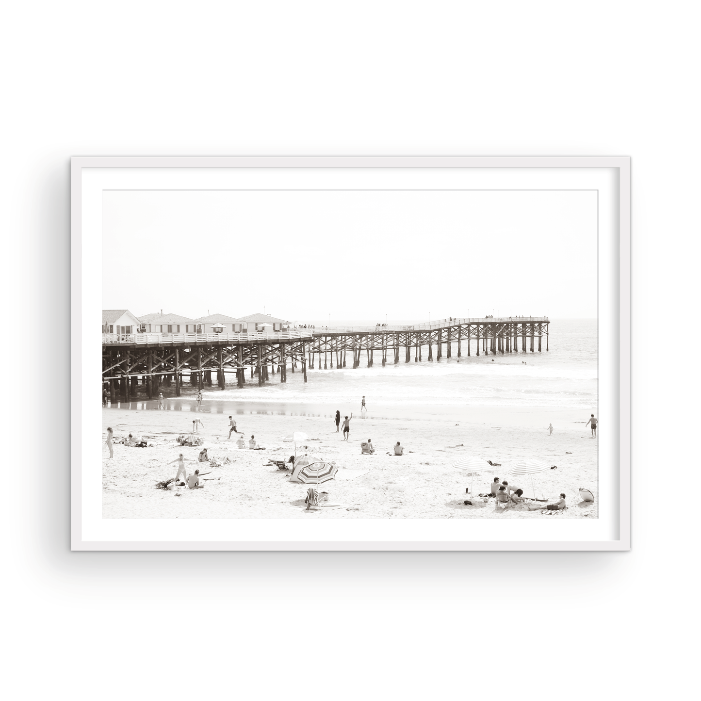 Sepia beach photo of Crystal Pier in Pacific Beach, San Diego, with people on the sandy beach. This framed coastal print showcases iconic beach scenes. Photograph in minimalist mock up.