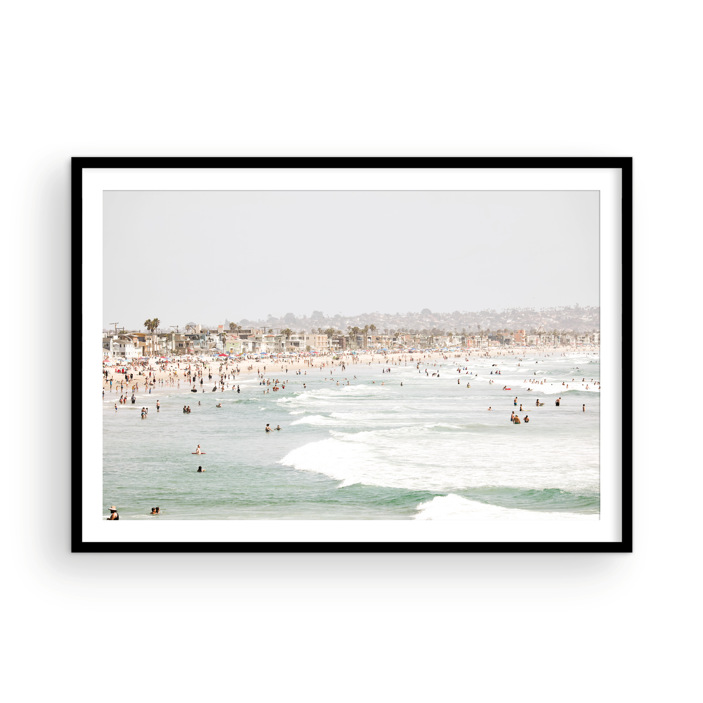 Landscape beach photography of a busy San Diego public beach with many people in the sand and ocean waves, a true summer vibes scene. Photograph in minimalist mock up.
