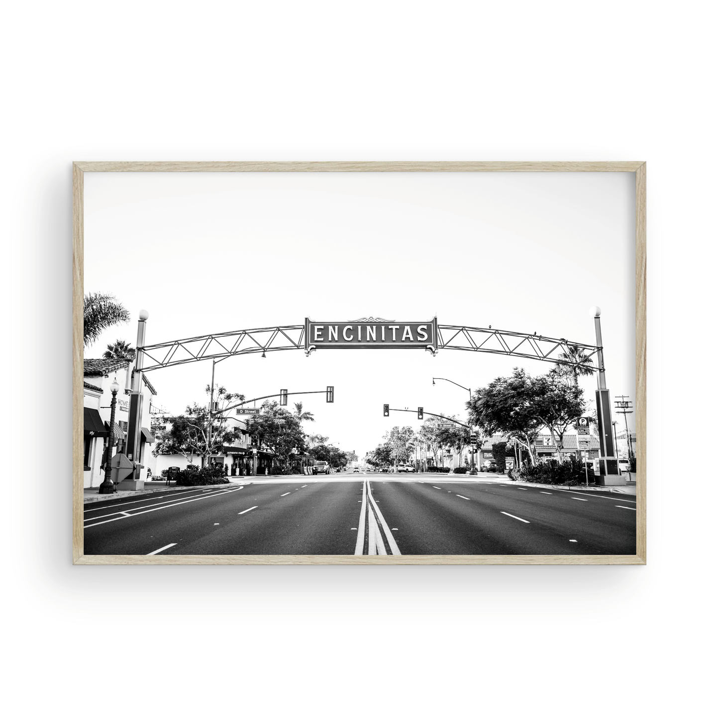A black and white photograph of a street sign that reads 'Encinitas' with a background of a city street. Photograph in minimalist mock up.