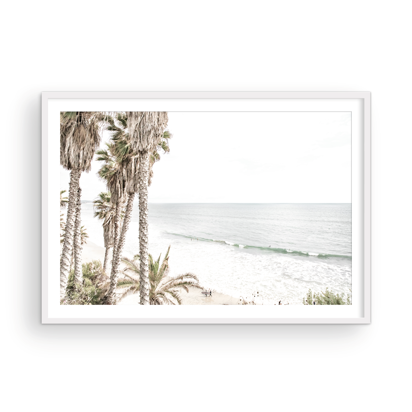 Dreamy coastal palm tree print featuring several tall palm trees with shaggy trunks, and surfers walking down the tranquil beach. This vertical tropical print is captured at Swamis Beach on the Southern California coast, is bathed in bright, hazy sunlight, creating a pastel beach art effect. Evokes serene summer vibes, perfect for beach house decor. Photograph in minimalist surf art mock up.