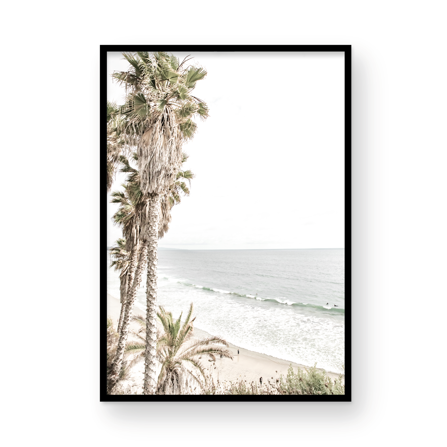 Dreamy coastal palm tree print featuring several tall palm trees with shaggy trunks, lining a gentle slope down to a tranquil beach. This vertical tropical print is captured at Swamis Beach on the Southern California coast, is bathed in bright, hazy sunlight, creating a pastel beach art effect. Evokes serene summer vibes, perfect for beach house decor. Photograph in minimalist surf art mock up.