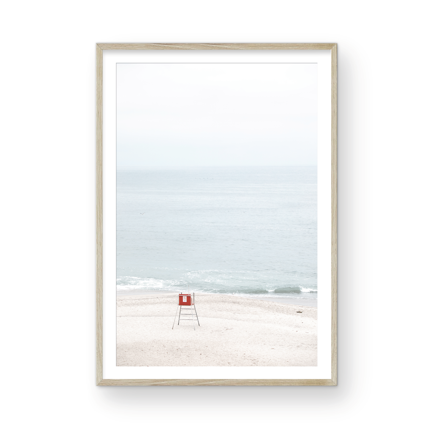 Vertical coastal photography featuring a red and white lifeguard chair and a calm ocean background, located in Laguna California. Photograph in minimalist mock up.