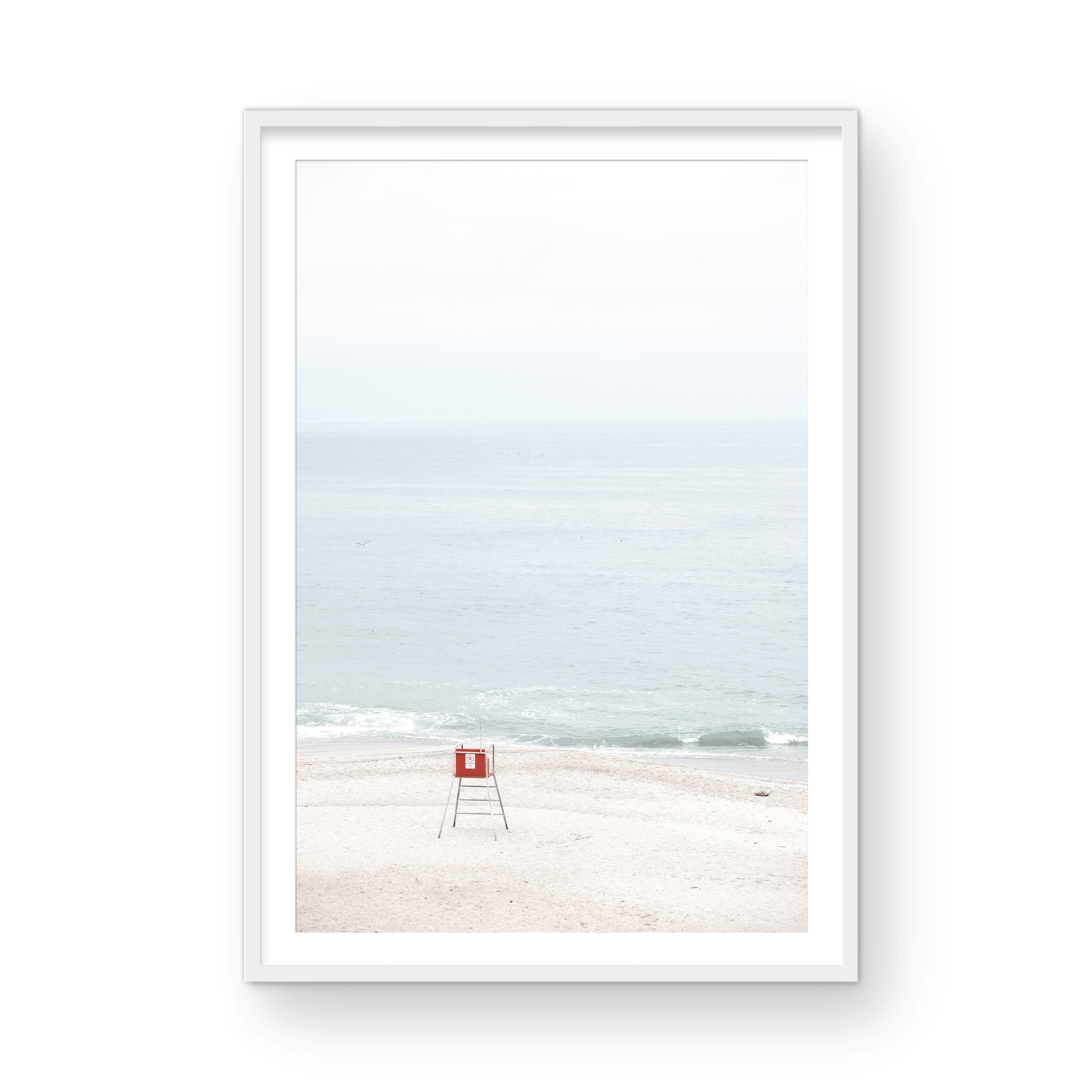 Vertical coastal photography featuring a red and white lifeguard chair and a calm ocean background, located in Laguna California. Photograph in minimalist mock up.