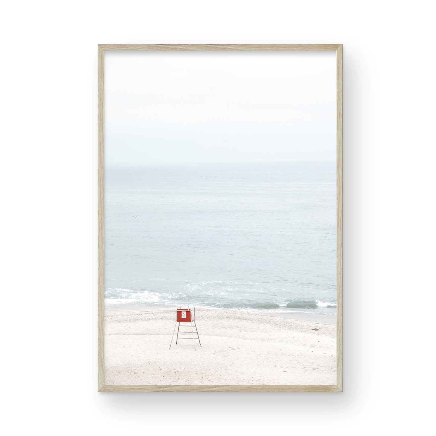 Vertical coastal photography featuring a red and white lifeguard chair and a calm ocean background, located in Laguna California. Photograph in minimalist mock up.