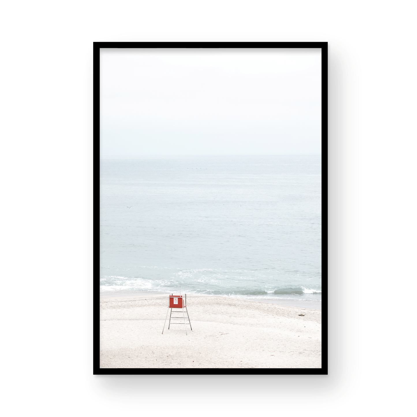 Vertical coastal photography featuring a red and white lifeguard chair and a calm ocean background, located in Laguna California. Photograph in minimalist mock up.