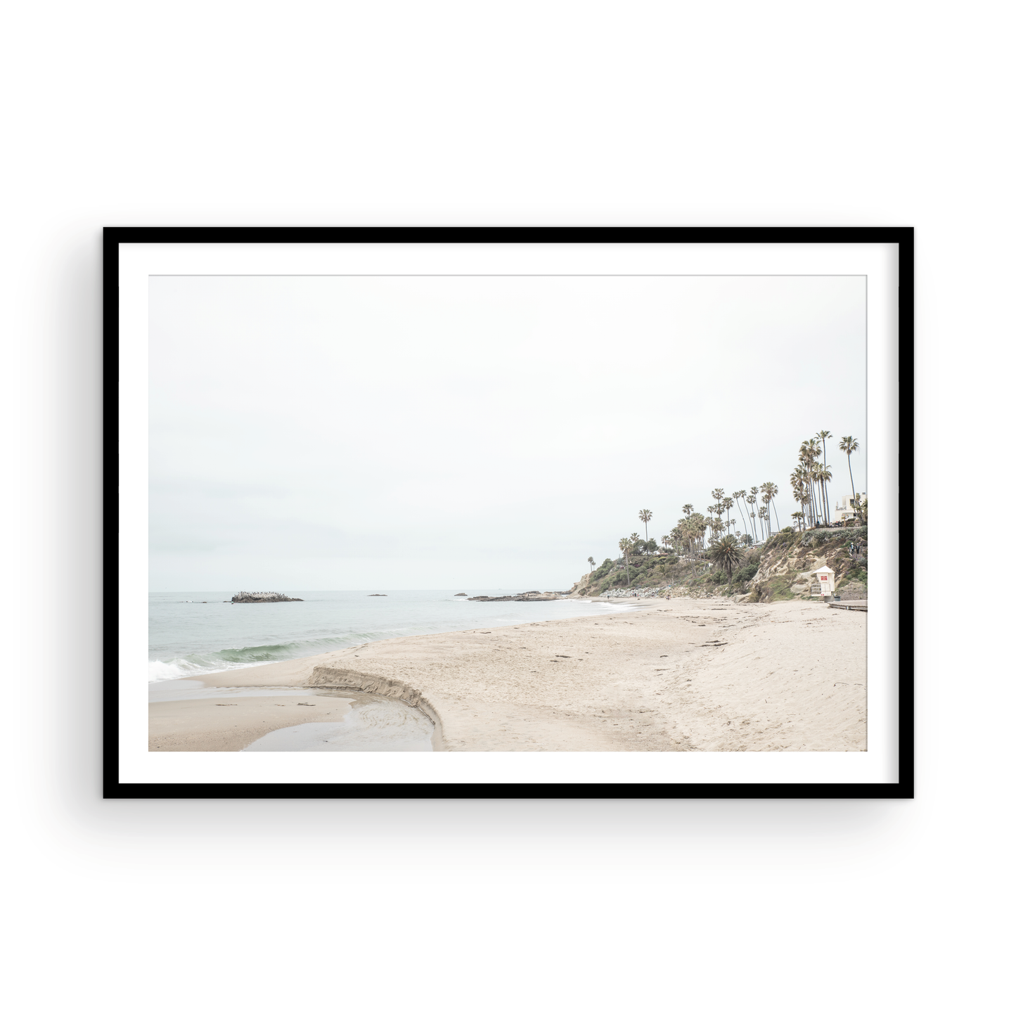 Horizontal coastal photography of a white lifeguard tower at Laguna Beach, California, depicting a beach scene with palm trees and a calm ocean. Photograph in minimalist mock up.