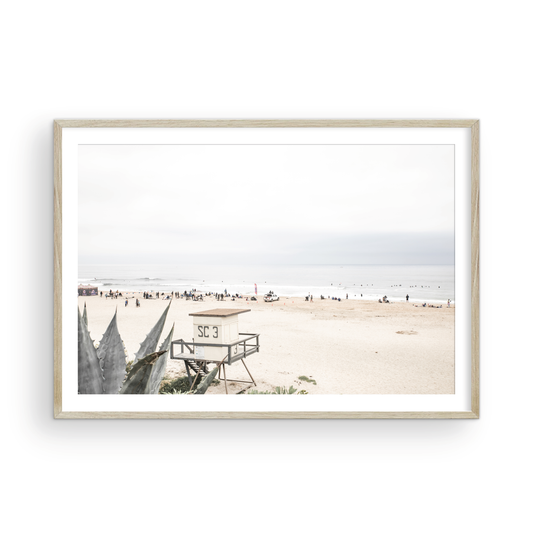 Landscape beach photography of Salt Creek Beach, with lifeguard tower SC 3 in the foreground, and many people enjoying the beach and ocean in the distance. A beach vibes print. Photograph in minimalist mock up.