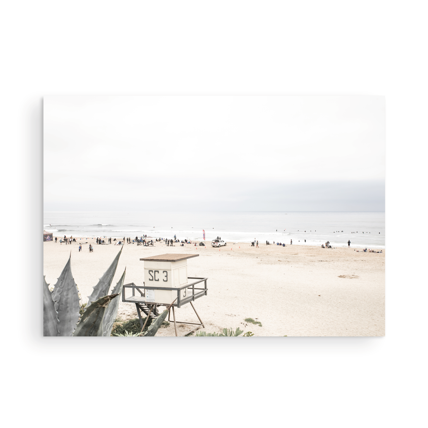 Landscape beach photography of Salt Creek Beach, with lifeguard tower SC 3 in the foreground, and many people enjoying the beach and ocean in the distance. A beach vibes print. Photograph in minimalist mock up.