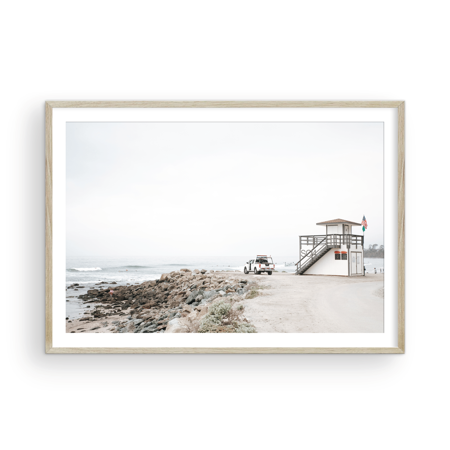 Landscape beach photography of Salt Creek Beach, with lifeguard tower SC 4 in the foreground, and many people enjoying the beach and ocean in the distance. A beach vibes print. Photograph in minimalist mock up.