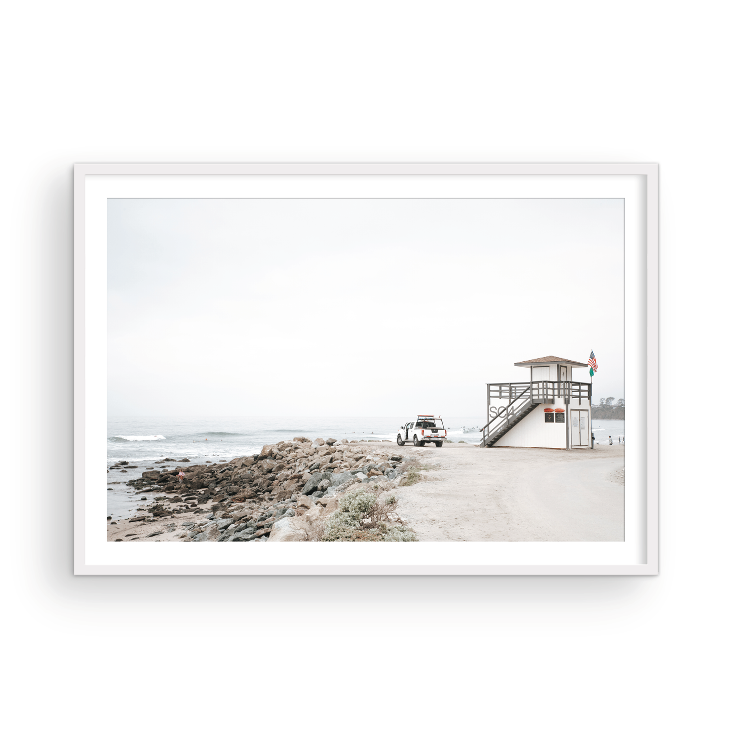 Landscape beach photography of Salt Creek Beach, with lifeguard tower SC 4 in the foreground, and many people enjoying the beach and ocean in the distance. A beach vibes print. Photograph in minimalist mock up.