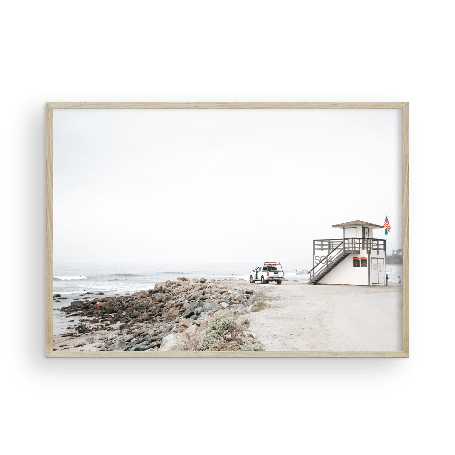 Landscape beach photography of Salt Creek Beach, with lifeguard tower SC 4 in the foreground, and many people enjoying the beach and ocean in the distance. A beach vibes print. Photograph in minimalist mock up.