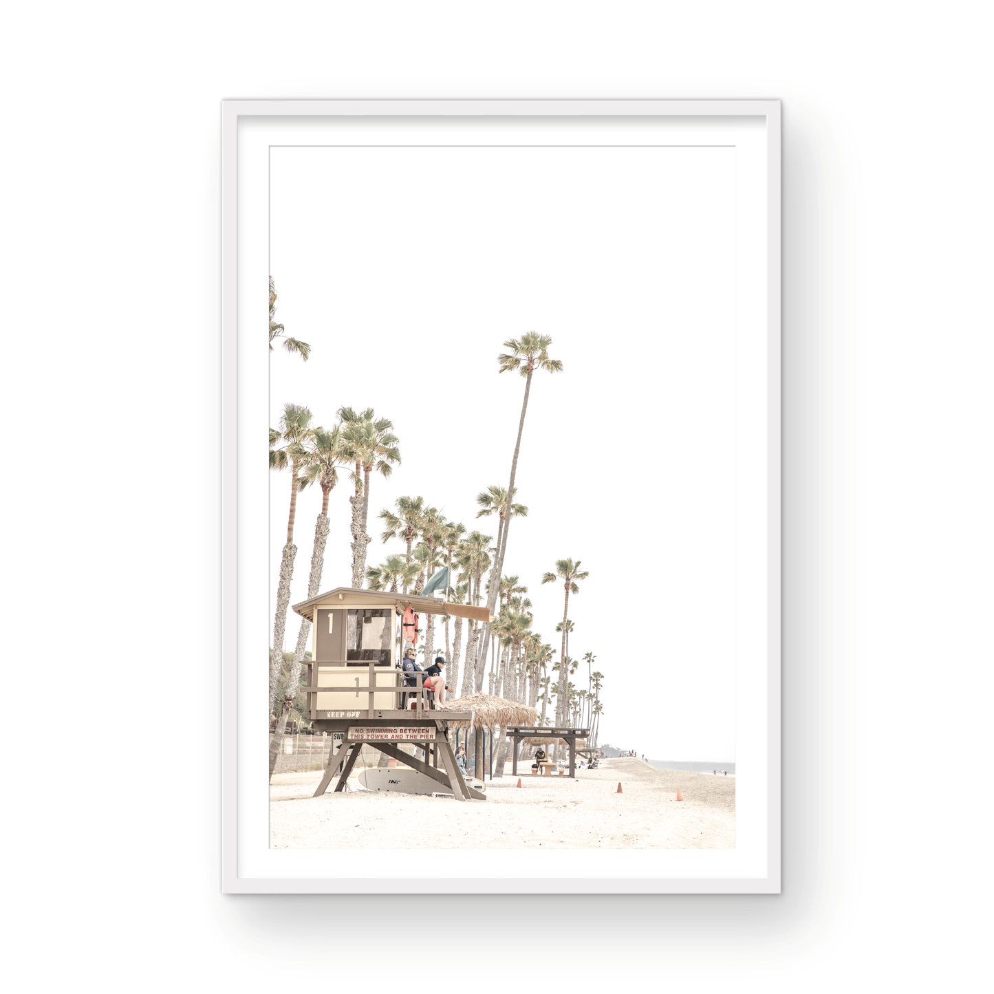 A landscape coastal photography view of San Clemente State Beach in Southern California, featuring a row of tall palm trees, a lifeguard tower, and people enjoying the calm beach. This vertical image evokes Summer Vibes Wall Art and tropical beach print aesthetics. Photograph in minimalist mock up.